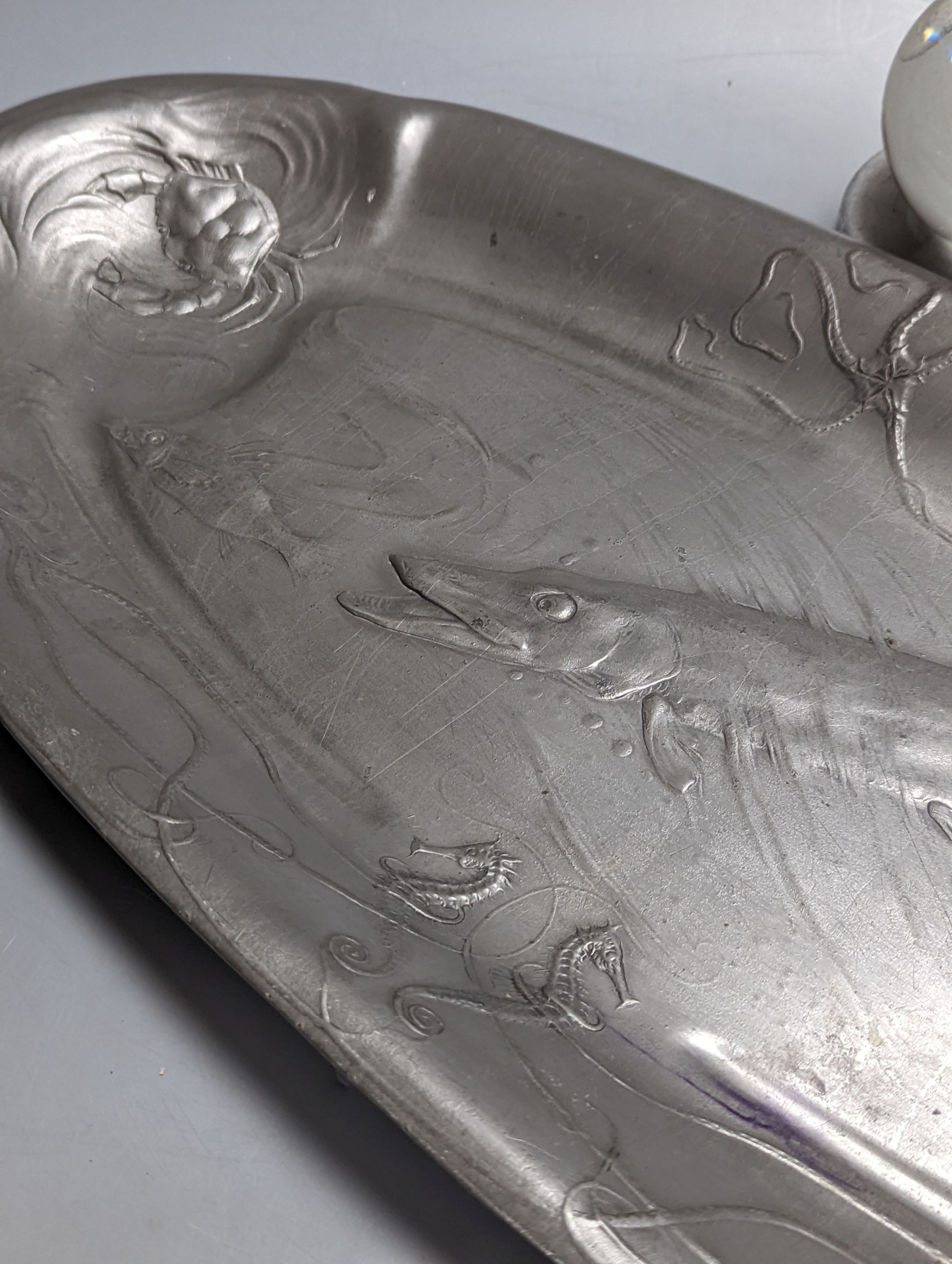A Kayserzinn oval salmon dish and an Art Deco chromium female statuette 62cm